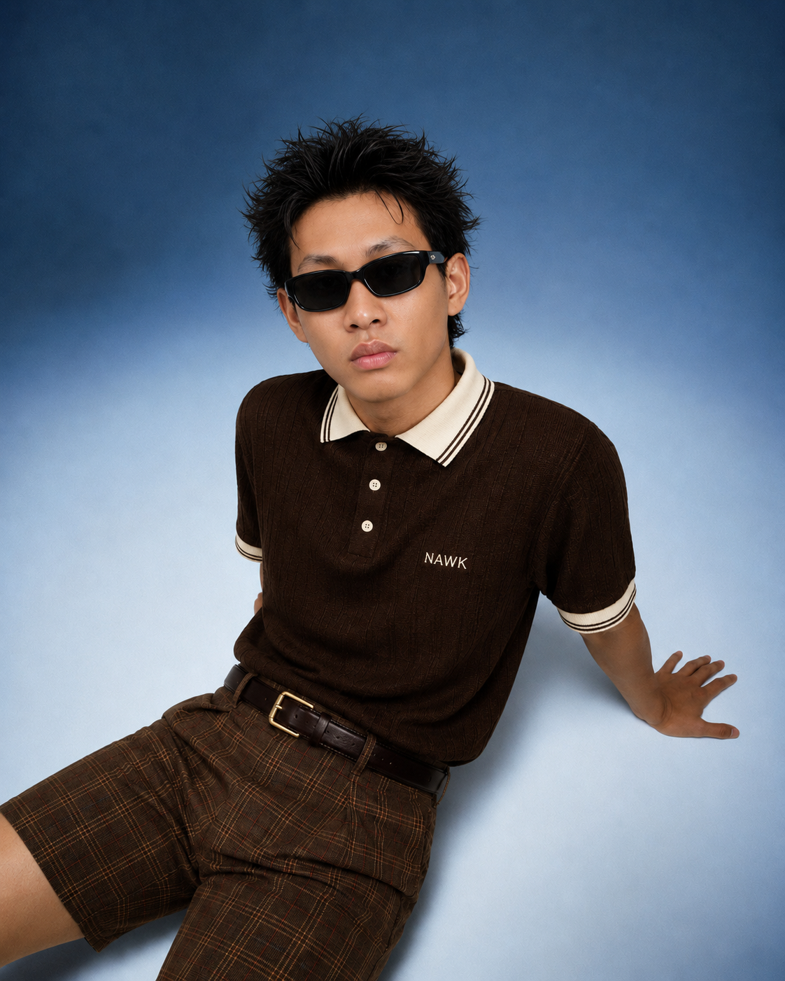 NAWK brown knit polo and checked shorts styled together